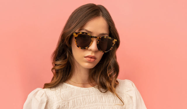 Woman in a white rouges blouse wearing Leonard II E Sunglasses in Tortoise