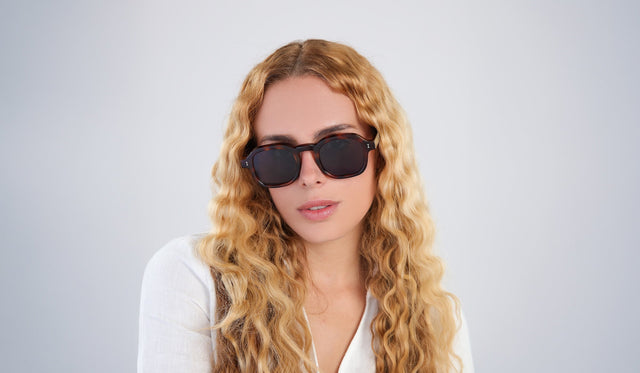 Woman with wavy blonde hair wearing Washington Sunglasses in Havana