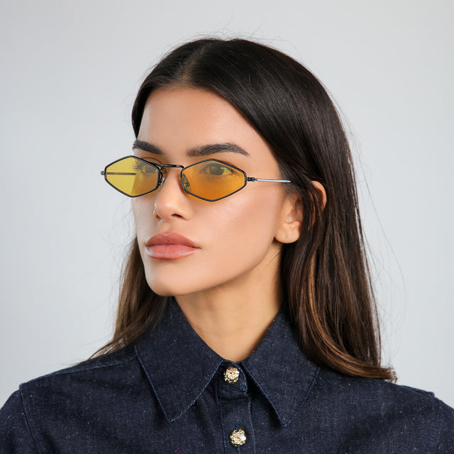 Another angle of woman with brown hair in a denim jacket wearing Astoria Sunglasses Black with Honey Flat See Through