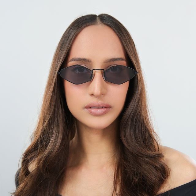 Woman with brown hair in an off-the-shoulder blouse wearing Astoria Sunglasses Matte Black with Grey Flat