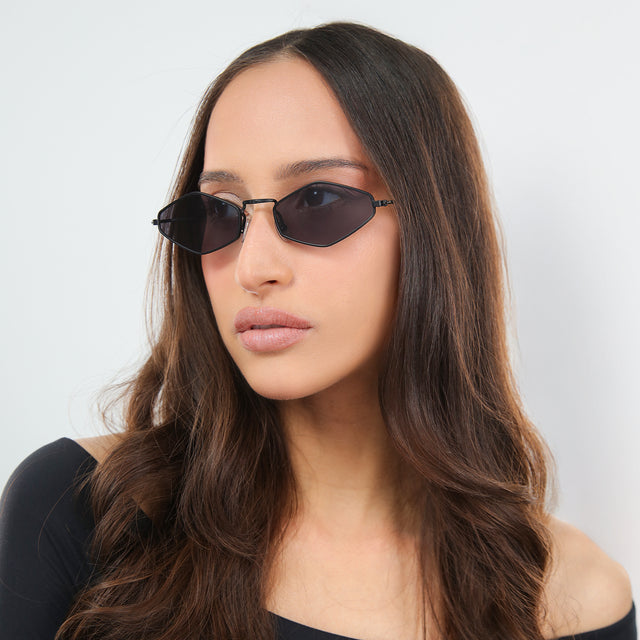 Another angle of woman in an off-the-shoulder blouse wearing Astoria Sunglasses Matte Black with Grey Flat