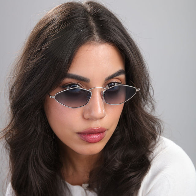 Another angle of brunette woman looking left wearing Austria Sunglasses Silver with Midnight Blue Flat Gradient