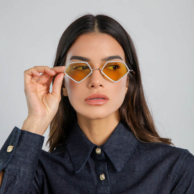 Brunette model in a denim blouse wearing Beak Ace 53 Sunglasses Celeste/Rose Gold with Honey Flat See Through