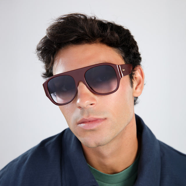 Man with brown hair in a navy jacket wearing Colorado Sunglasses Bordeaux with Grey Gradient