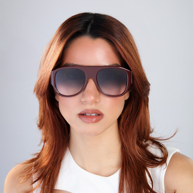 Woman with red hair in a white blouse wearing Colorado Sunglasses Bordeaux with Grey Gradient