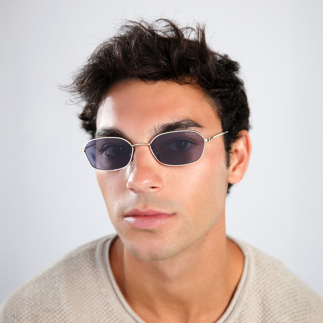 Another angle of man with brown hair in a taupe shirt wearing East Houston Sunglasses Gold with Grey Flat
