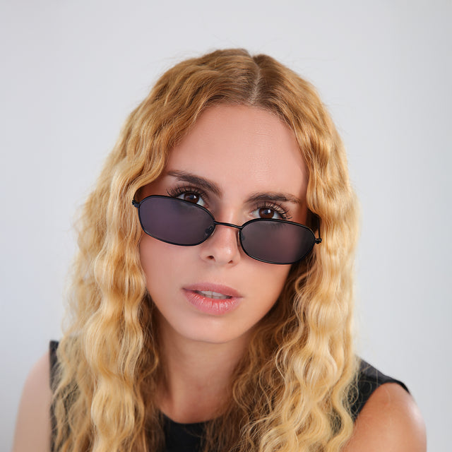 Another angle of woman with blonde, wavy hair wearing East Houston Sunglasses Matte Black with Grey Flat