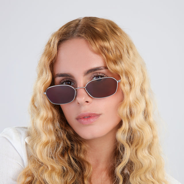 Another angle of woman with blonde, wavy hair wearing East Houston Sunglasses Silver with Brown Flat
