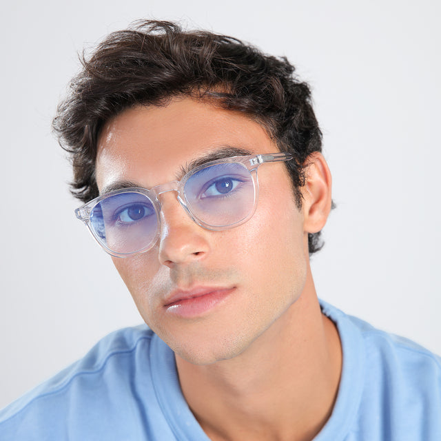 Man with brown hair in a blue shirt wearing Eldridge Sunglasses Clear with Blue Flat Gradient See Through