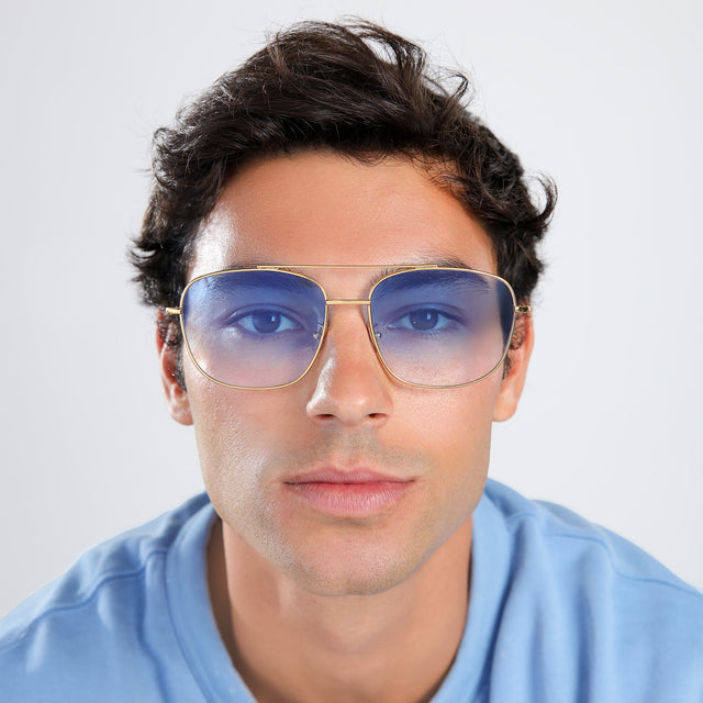 Another angle of man with brown hair in a light blue shirt wearing Frankie Sunglasses Gold with Blue Flat Gradient See Through