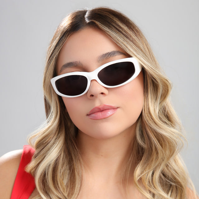 Woman with highlights in a red blouse wearing Granada Sunglasses White