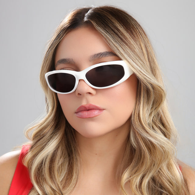Another angle of woman with highlights in a red blouse wearing Granada Sunglasses White