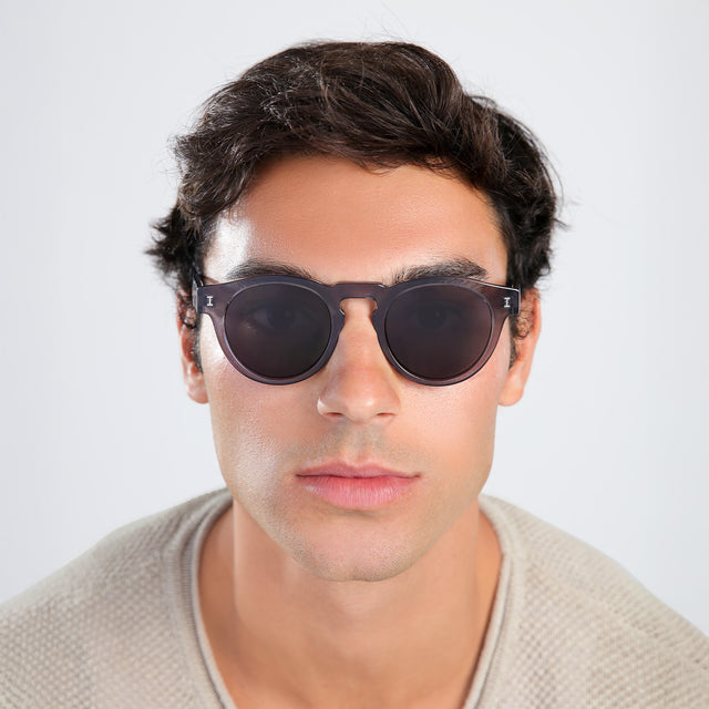 Another angle of man with brown hair in a beige waffled sweatshirt wearing Leonard Sunglasses Mercury with Grey