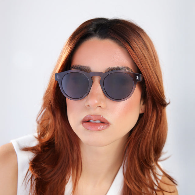 Woman with red hair in a white blouse wearing Leonard Sunglasses Mercury with Grey