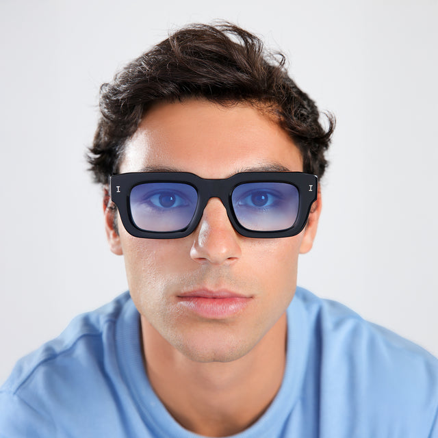 Another angle of man with brown hair in a baby blue shirt wearing Lewis 50 Sunglasses Black with Blue Flat Gradient See Through