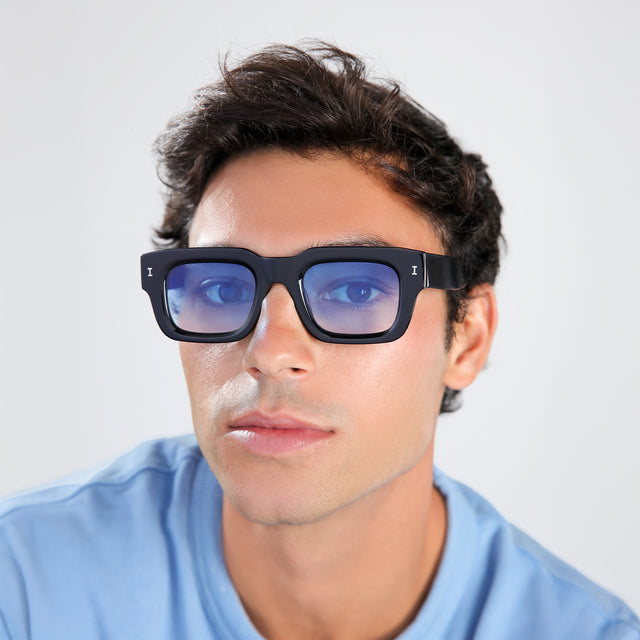 Man with brown hair in a baby blue shirt wearing Lewis 50 Sunglasses Black with Blue Flat Gradient See Through
