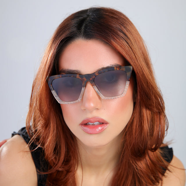 Close up of woman with red hair in a black blouse Lisbon Sunglasses side view in H/H Maple Bone / Grey Gradient