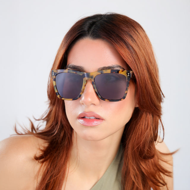 Another angle of woman with red hair in an olive blouse wearing Los Feliz Sunglasses Tortoise with Grey