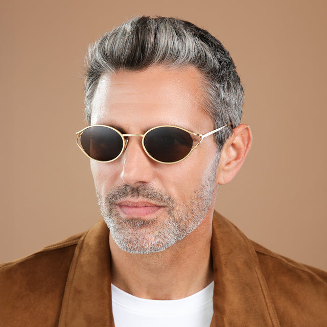 Another angle of man in a suede jacket wearing Maria Sunglasses Gold with Brown