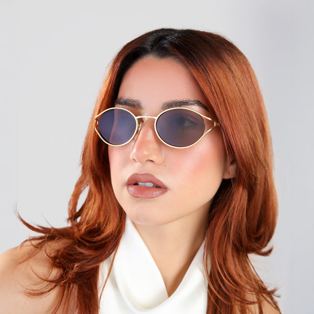 Another angle of woman in a white blouse wearing Maria Sunglasses Gold with Brown