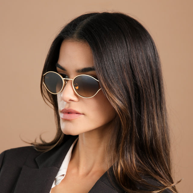 Side profile of brunette model wearing Maria Sunglasses Rose Gold with Taupe Gradient