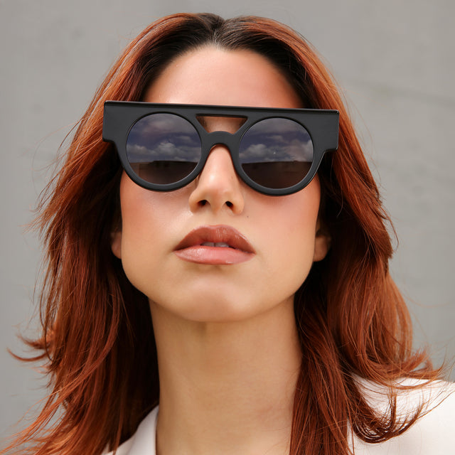 Another angle of model with red hair wearing Meyer (15 Year Anniversary) Sunglasses Matte Black with Grey Flat