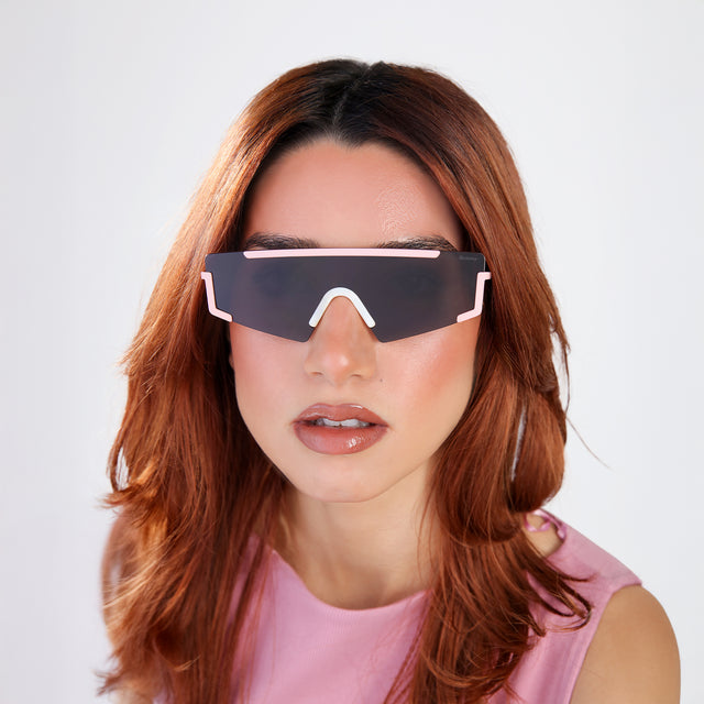 Another angle of woman with red hair in a bubblegum pink blouse wearing Morph Sunglasses Baby Pink/Cream Marble with Grey