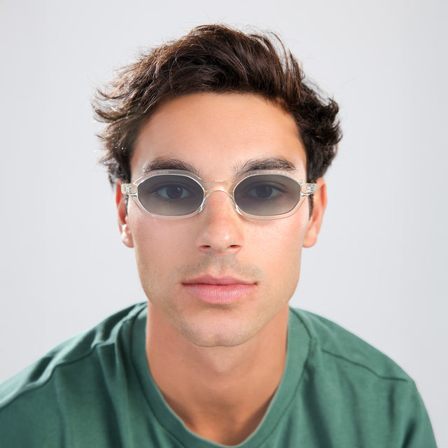 Man with brown hair in a green shirt wearing Munich Sunglasses Champagne with Olive Flat Gradient