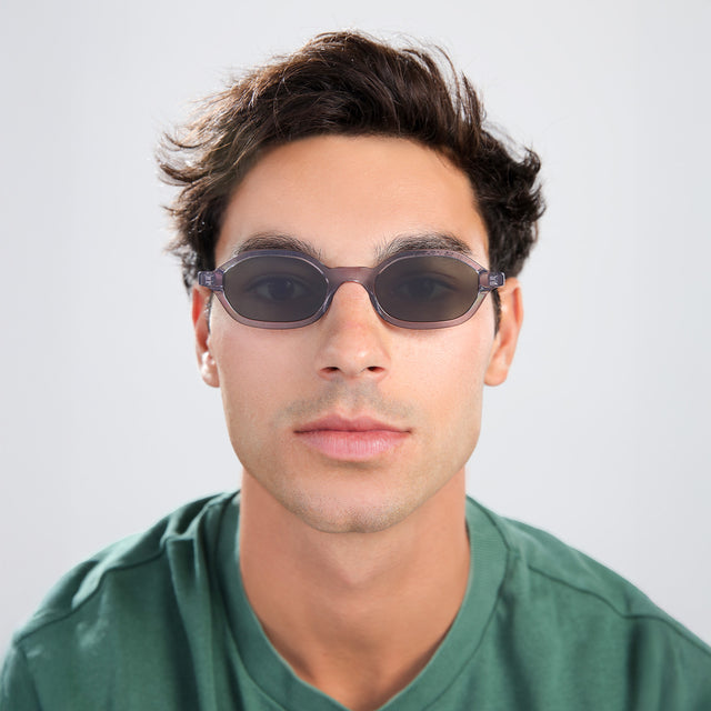Man with brown hair in a green shirt wearing Munich Sunglasses Mercury with Olive Flat