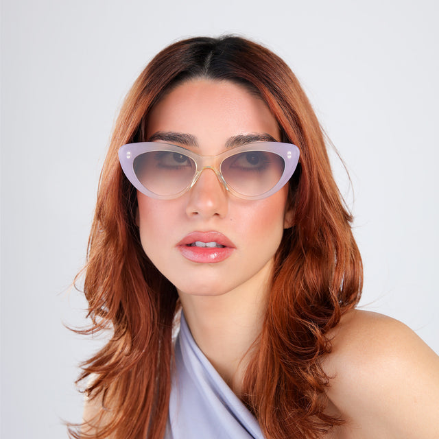 Woman with red hair in a dusty blue blouse wearing Pamela Sunglasses Split Champagne Lilac with Brown Flat Gradient