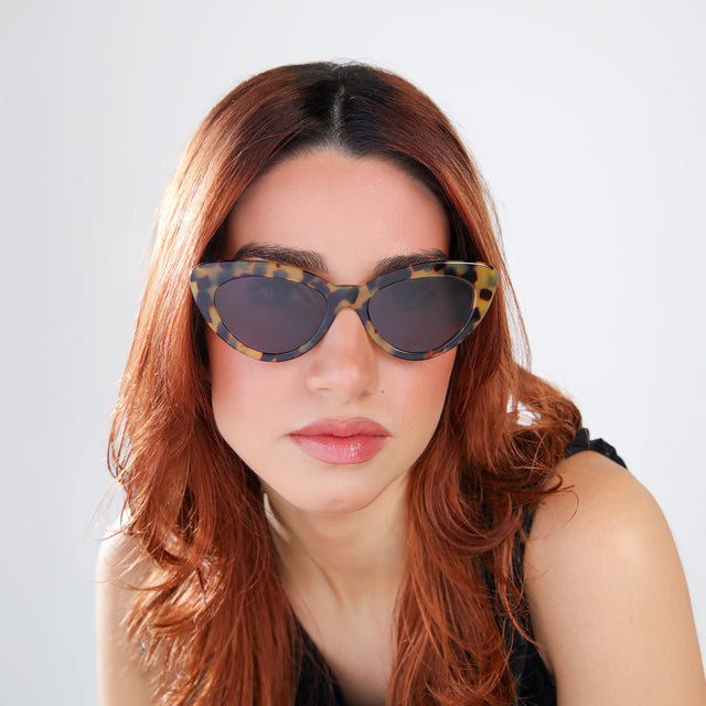 Another angle of woman with red hair wearing Pamela Sunglasses Tortoise with Grey Flat