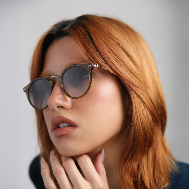 Model with red hair wearing Portofino Sunglasses Moss with Grey Gradient