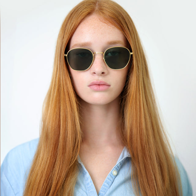Model with straight red hair wearing Prince Sunglasses Gold with Olive Flat