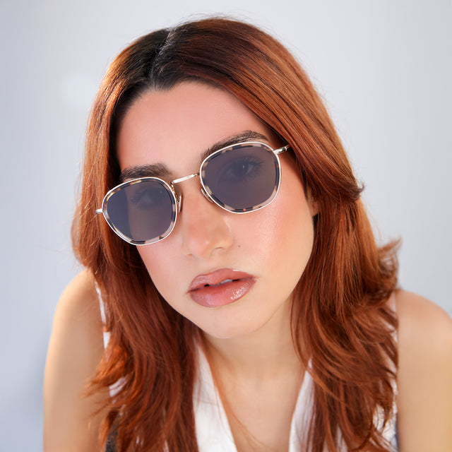Close up of woman with red hair in a white blouse wearing Prince Tate Sunglasses White Tortoise/Gold with Grey Flat