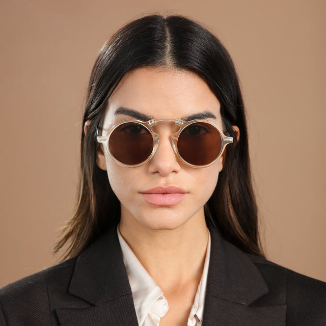 Brunette model in a blazer wearing Roma II Sunglasses Champagne with Brown Flat