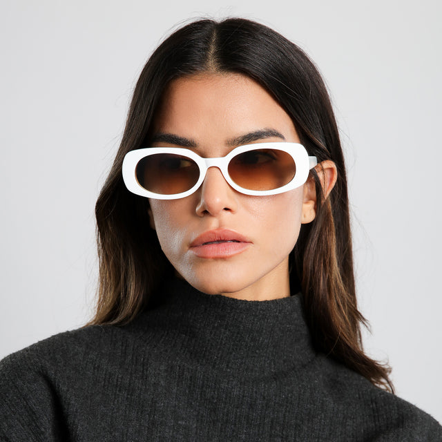 Model in dark gray turtleneck wearing Shirley 51 Sunglasses White with Brown Gradient