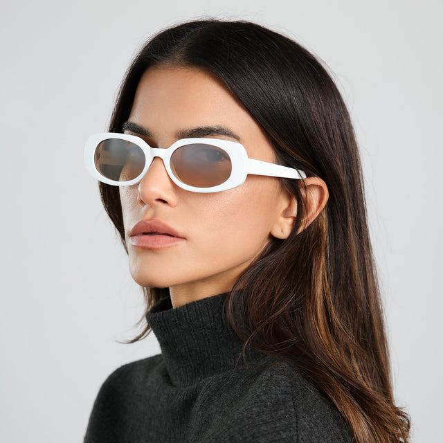 Model in dark gray turtleneck looking to her left wearing Shirley 51 Sunglasses White with Brown Gradient