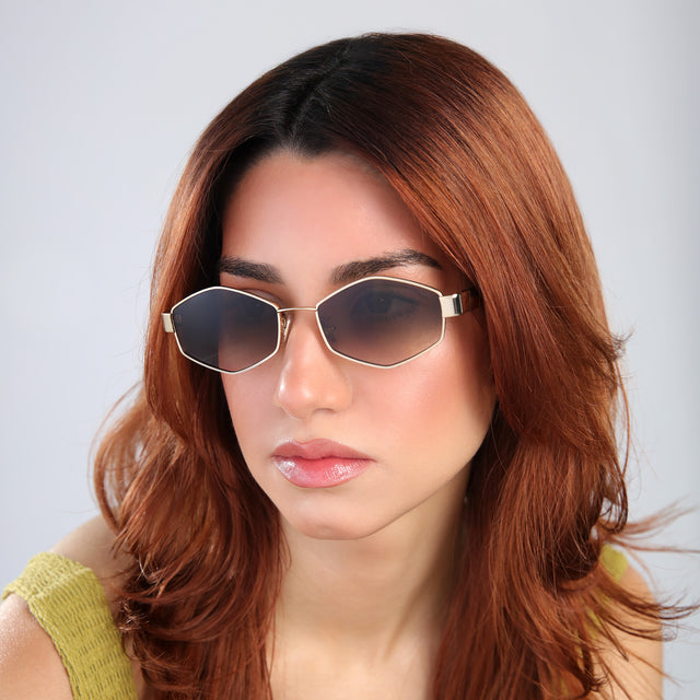 Woman with red hair in a white blouse wearing Tucson Sunglasses Gold/Havana with Taupe Gradient