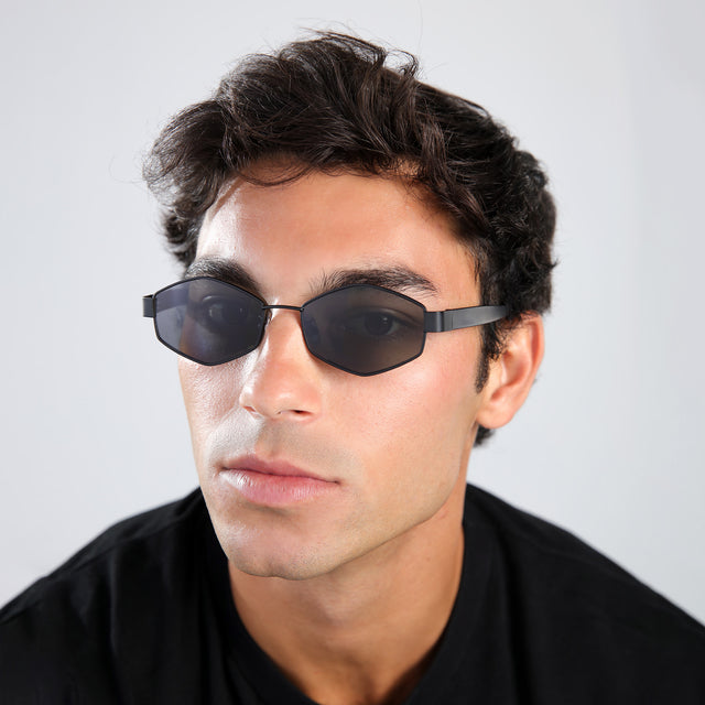 Man in a black shirt wearing Tucson Sunglasses Matte Black with Grey