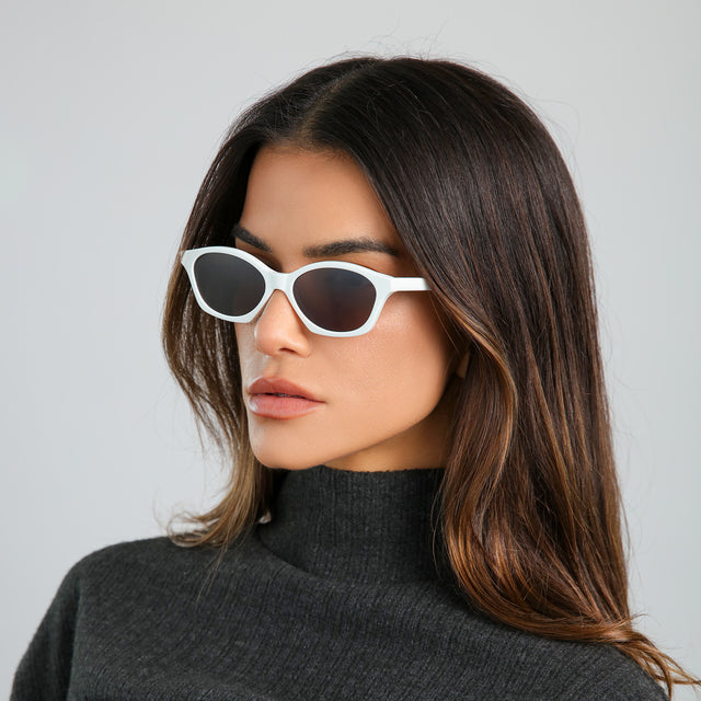 Another angle of brunette woman wearing Vilma Sunglasses Light Grey with Grey