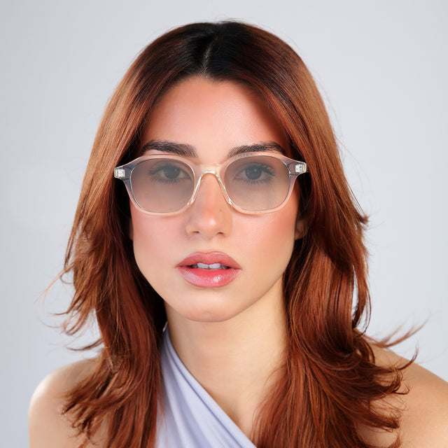 Close up of woman with red hair in a baby blue blouse wearing William Sunglasses Champagne with Taupe Gradient