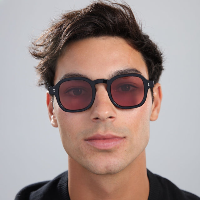 Man with brown hair in a black shirt wearing Washington Sunglasses Black with Bordeaux Flat See Through