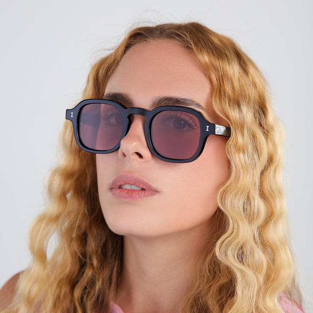 Another angle of blonde woman with curly hair wearing Washington Sunglasses Black with Bordeaux Flat See Through