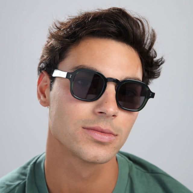 Another angle of man with brown hair in a black shirt wearing Washington Sunglasses Pine with Grey Flat