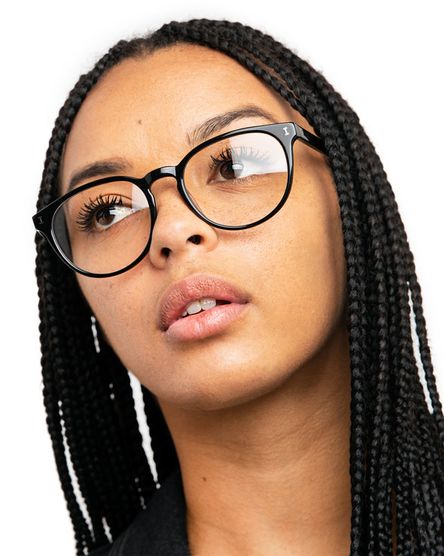 Brunette model with box braids wearing Bristol 52 Optical Black Optical
