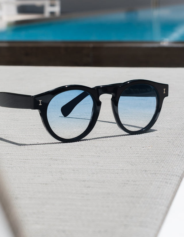 Leonard Sunglasses in front of a pool, with a focus on the lenses