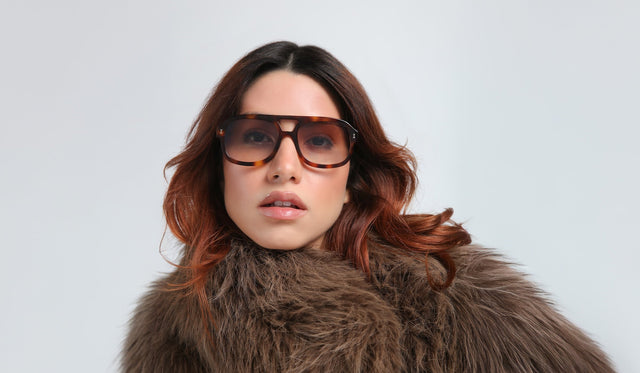 Woman in a faux fur coat wearing the Memphis Sunglasses