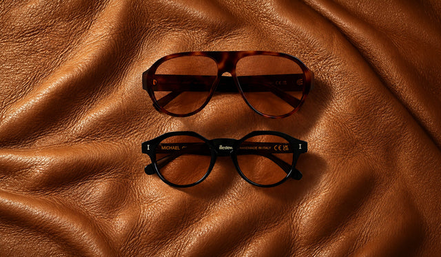 Telluride and Michael Sunglasses in new Desert see through lens options over a brown leather couch cushion