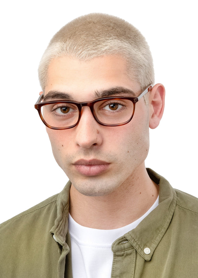 Model with blonde buzzcut wearing Albany Optical Havana Optical