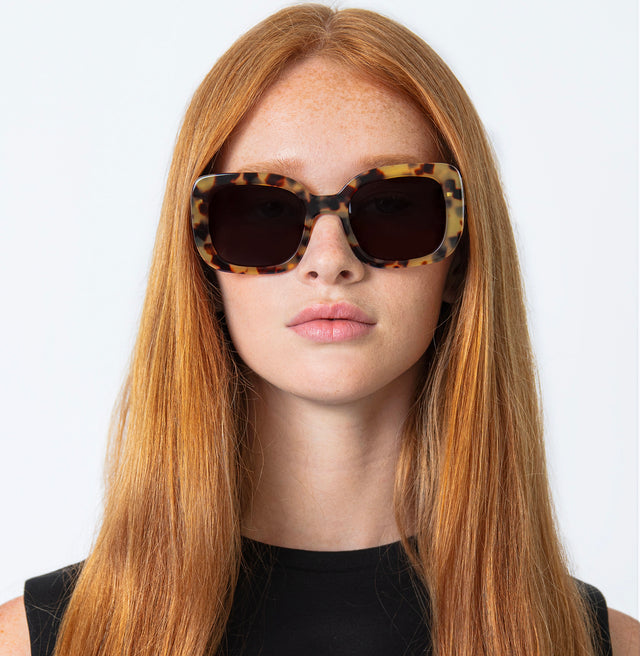 Model with straight red hair wearing Anastasia Sunglasses Tortoise W